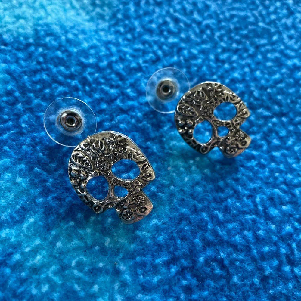 Sterling silver skull studs with floral symbols